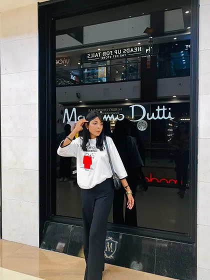 Posing outside a store in my casual black and white outfit. This look is all about comfort without sacrificing style.