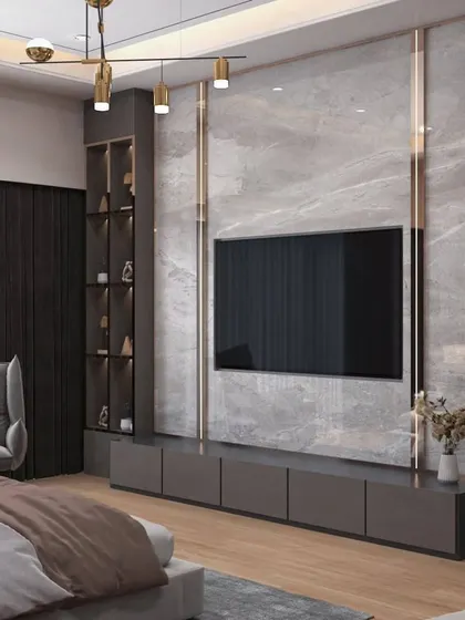 This bedroom TV unit combines a marble-finish feature wall with dark wood shelving and integrated lighting. It provides a cinematic experience while maintaining a cohesive and luxurious bedroom aesthetic.