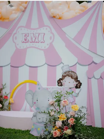A close-up of the circus tent backdrop, featuring a cute elephant and ringmaster illustration.