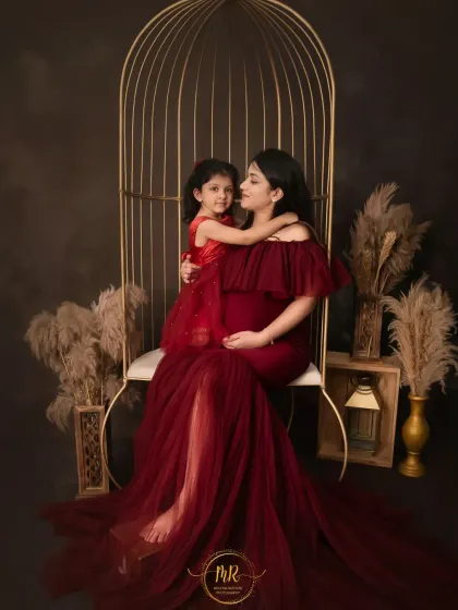 A mother and daughter share a loving embrace during a maternity shoot. I offer matching or complementary outfits from my curated wardrobe for moments like these.