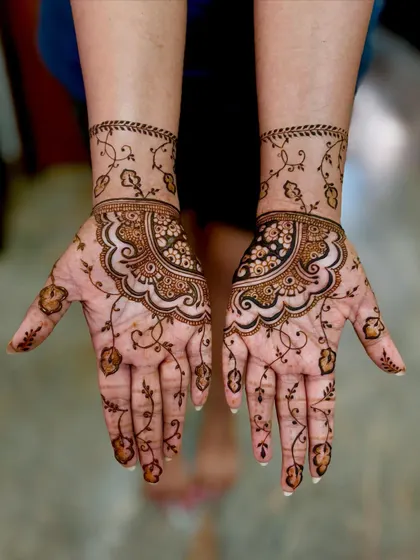 A special design for a repeat client's reception, featuring a delicate floral vine pattern. I was honored to do her engagement, wedding, and reception mehendi.