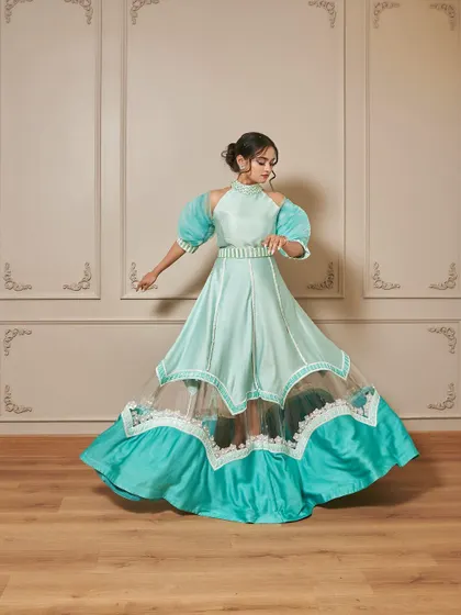 A full-length shot of the 'Jasmine' gown, showing how the skirt creates a beautiful flare. The color is perfect for daytime events like a mehendi or sangeet.
