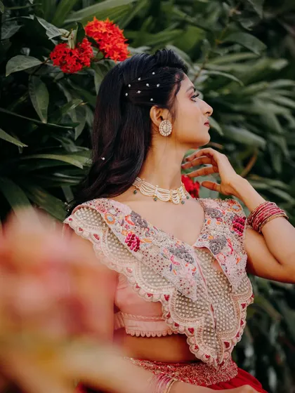 A side profile showing the pretty pearl hair accessories and the soft, romantic hairstyle.