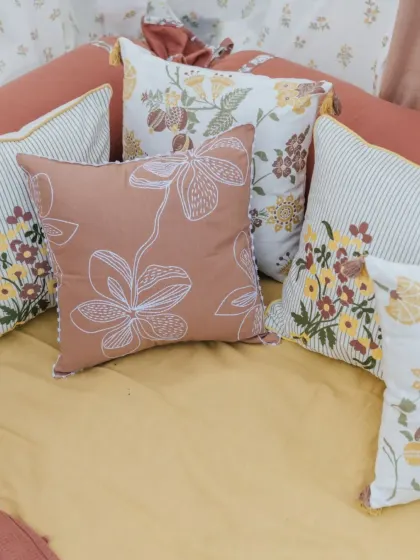 A beautiful pile of cushions from our 'Pause' collection, showcasing a symphony of soft tones, floral prints, and line art. These are perfect for creating a dreamy, romantic feel.
