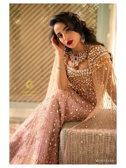 A stunning portrait of the model. Her makeup is pure Hollywood glamour, with a flawless red lip and radiant skin that catches the light beautifully.