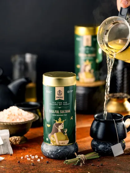 A pour shot of Hindraj's Soulful Sultana tea into a dark, elegant mug. The action of the pour and the steam rising from the cup create a dynamic and comforting image, perfect for a tea lover.