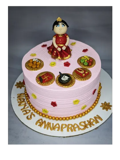 A special cake for an Annaprashan ceremony, which marks a baby's first taste of solid food. This fresh pineapple cake is decorated with traditional and symbolic fondant toppers.
