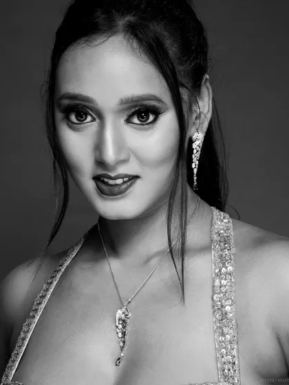 A smiling black and white portrait, capturing a moment of connection with the camera.