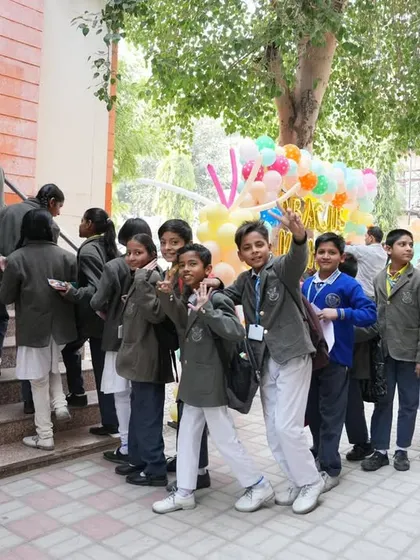More students arriving for the national competition, waving and smiling for the camera.