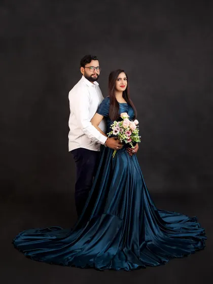A beautiful portrait of the couple holding a bouquet of flowers together. It's a lovely symbol of the new life they have created and are nurturing.