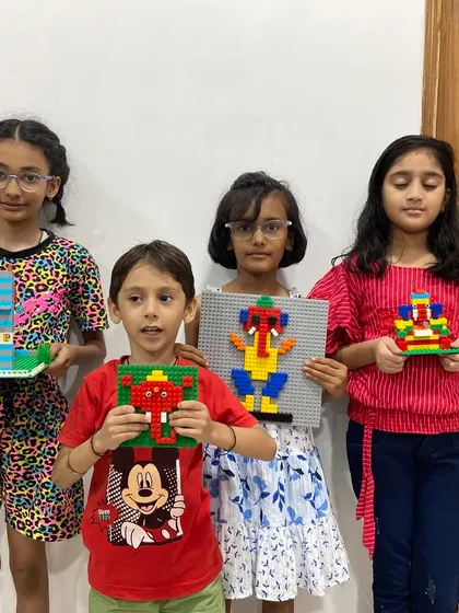 A group of students proudly display their unique LEGO Ganesha creations from our Ganesh Chaturthi workshop. These events combine cultural learning with creative engineering.