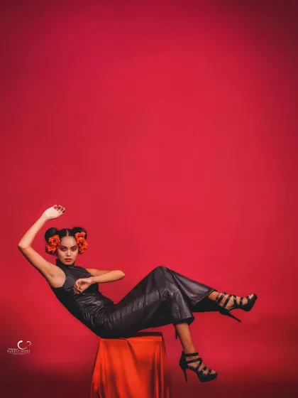 A dynamic, reclining pose that is both elegant and daring. The use of negative space is excellent, drawing the eye to the subject.