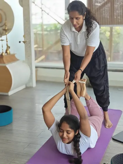 Another example of a strap-assisted Dhanurasana, showing how we provide personalized support to each TTC student to help them open their hearts and strengthen their backs safely.