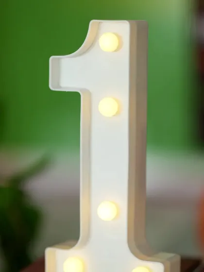 A close-up of a light-up number '1' prop. These marquee numbers are a popular addition to first birthday celebrations and make for great photos.