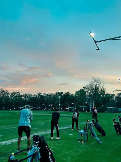 The driving range at sunset is a truly special experience. The beautiful sky adds another layer to your evening practice session.