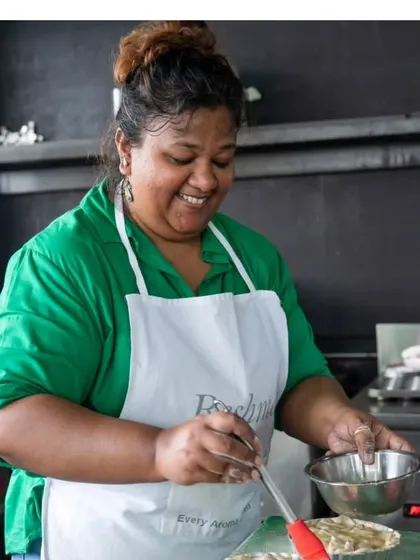 In the kitchen, putting the final touches on my pie before it goes into the oven. I love blending traditional Indian flavours with different formats.