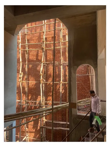 Another view during construction, showing the play of light and shadow on the raw brick and concrete surfaces.