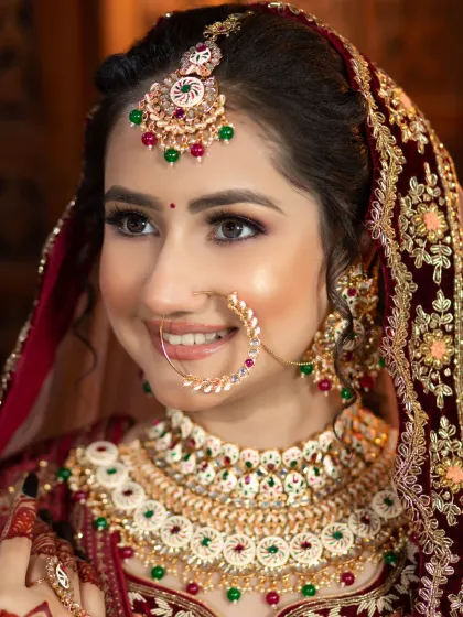 A close-up of a smiling bride, showcasing the detailed eye makeup and the smooth, airbrushed finish of the skin. This look is perfect for brides who want to look flawless from every angle.