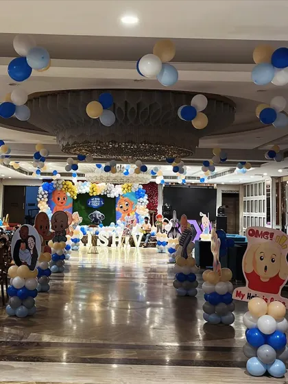 A wide view of the hall for the Mundan ceremony, showing how we decorated the entire space with themed balloon pillars and cutouts.