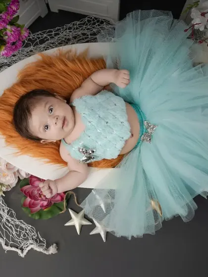 A tiny mermaid in a sea of dreams. This newborn portrait showcases one of my creative studio setups, complete with a boat prop and nautical details.