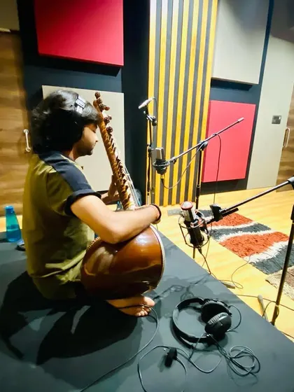 A shot from behind during the recording session at TAG Institute. You can see the professional multi-mic setup used to capture every nuance of the sitar's sound.