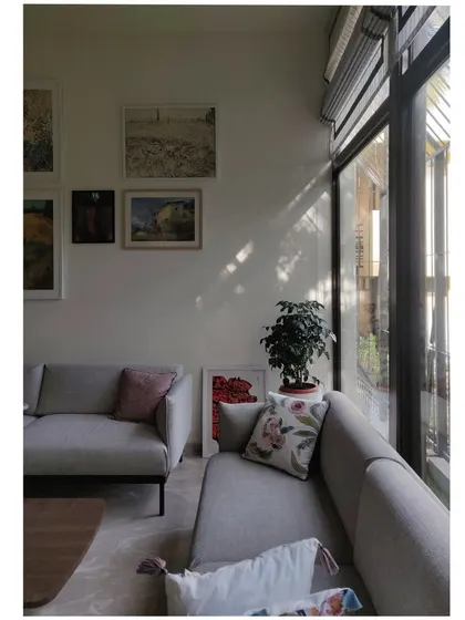 A wider view showing how the window frames create a grid of light on the wall and floor, adding a dynamic geometric element to the space.