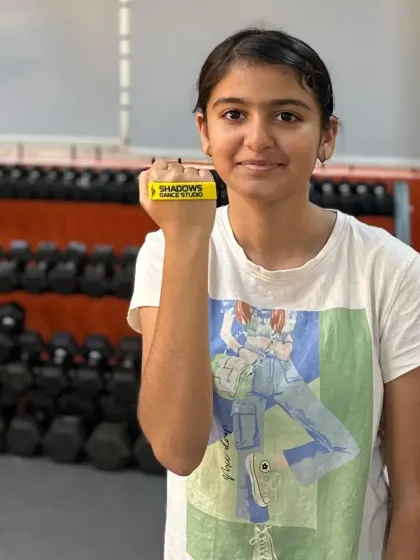 Tanisha Kaher shows off her new yellow band after a top performance in the basic level. Congratulations on your achievement.