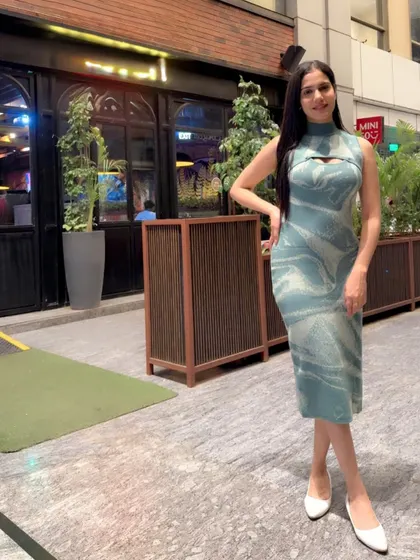A stylish look in a modern, patterned midi dress, perfect for a casual evening out or a lifestyle brand shoot.