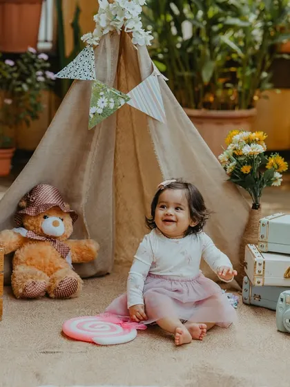 Celebrating half a year! This outdoor six-month milestone session with a cute teepee setup is a great way to capture the halfway point to one.