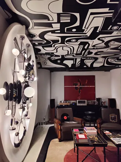 A different perspective of the 'Sistine Chapel' ceiling mural, this view shows how the bold, graphic labyrinth pattern interacts with the room's lighting and decor. The design creates a powerful sense of movement and depth.