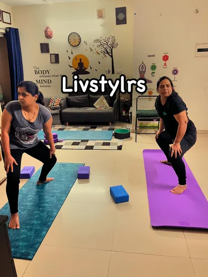Two clients practice Utkata Konasana (Goddess Pose), a powerful stance that builds strength in the lower body and opens the hips.