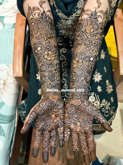 A beautiful example of full-hand mehendi where the palms are filled with detailed rose patterns, a favorite among my brides.