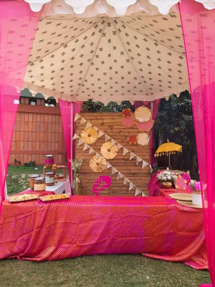 A vibrant pink food stall, perfect for serving chaat or other snacks at a festive event. The decor is bright, colorful, and inviting.