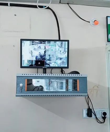 A complete setup for a small office in Varthur, showing the monitor and the locked network rack mounted securely on the wall.