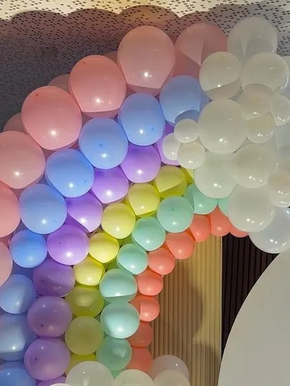 A beautiful pastel rainbow balloon arch, a popular and cheerful choice for baby showers and first birthdays.