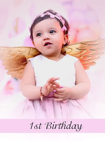 A sweet portrait of a little girl on her first birthday, dressed as an angel. This image is perfect for birthday invitations or thank you cards.