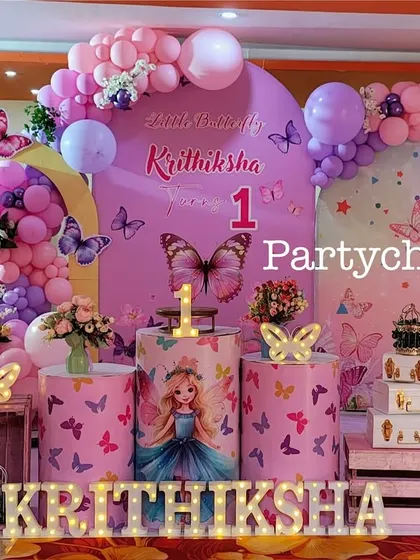 A close-up of the butterfly-themed stage, highlighting the detailed props and balloon work.