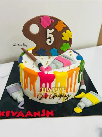 Sweet strokes of joy for a little artist. This colorful paint-palette drip cake is perfect for a creative 5th birthday.