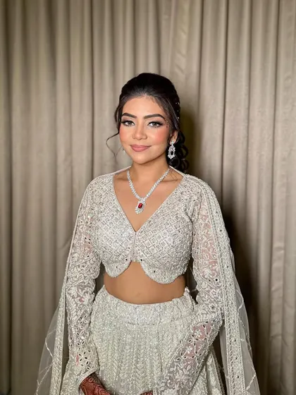 A full portrait of Ruchita's sangeet look. I paired a soft smokey eye with a neutral pink lip to balance her dazzling silver lehenga.