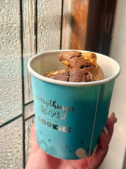 "Everything's better with Cookies." A tub of our chunky chocolate chip cookies, perfect for a comforting snack or a casual gift.