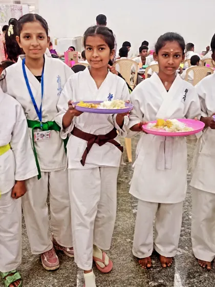 A group of my junior and senior female students posing with their breakfast. They are all fueled up and ready for the tournament.