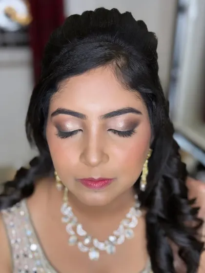 A classic reception look for this beauty. The focus is on a soft brown smokey eye that defines and elongates the eyes, paired with a subtle pink lip and glowing skin. It's glamorous yet feels light and comfortable.