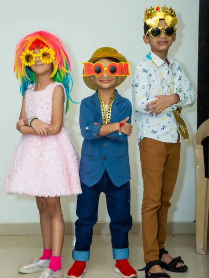 My box of selfie props brings out the fun in everyone. These kids are showing off their cool new looks with colorful wigs, silly glasses, and party chains.