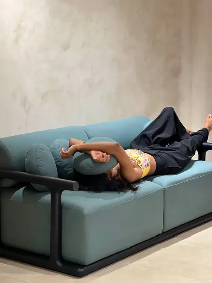 This teal sofa, with its clean lines and black wood frame, is another example of my comfortable yet stylish seating. It’s sturdy enough for playful lounging, as demonstrated here.