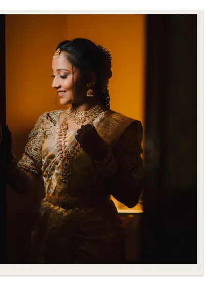 A candid shot of the bride getting ready, her smile captured in a moment of quiet reflection.