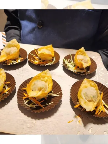 Crispy fried Chicken Wontons served on a bed of shredded carrots. These bite-sized delights are a perfect pass-around snack for any occasion.