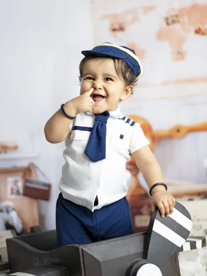 This cheeky pilot is ready for takeoff. We love capturing these funny, personality-filled moments during our themed shoots.