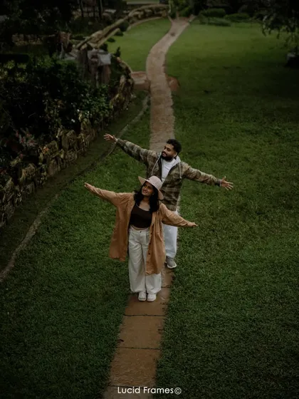 An aerial shot of the couple walking down a path, creating a beautiful, symmetrical composition.