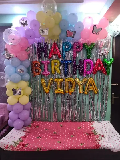 A sweet butterfly theme for Vidya's 4th birthday, with a pastel balloon arch and a silver shimmer backdrop.