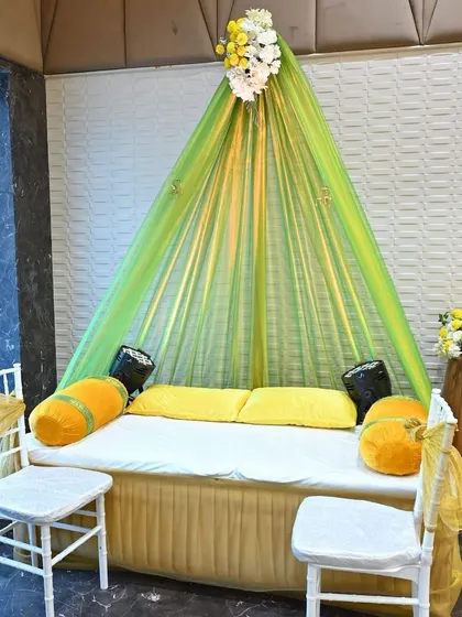 A cozy seating arrangement for the bride during her Mehendi ceremony. The lime green and yellow draping creates a fresh and festive look.
